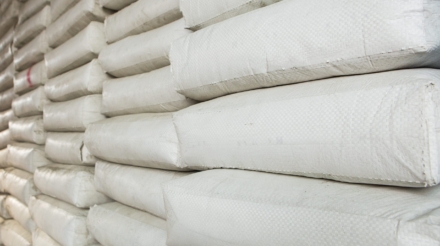 Pile,Of,White,Plastic,Sacks,In,Warehouse