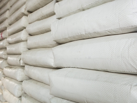 Pile,Of,White,Plastic,Sacks,In,Warehouse