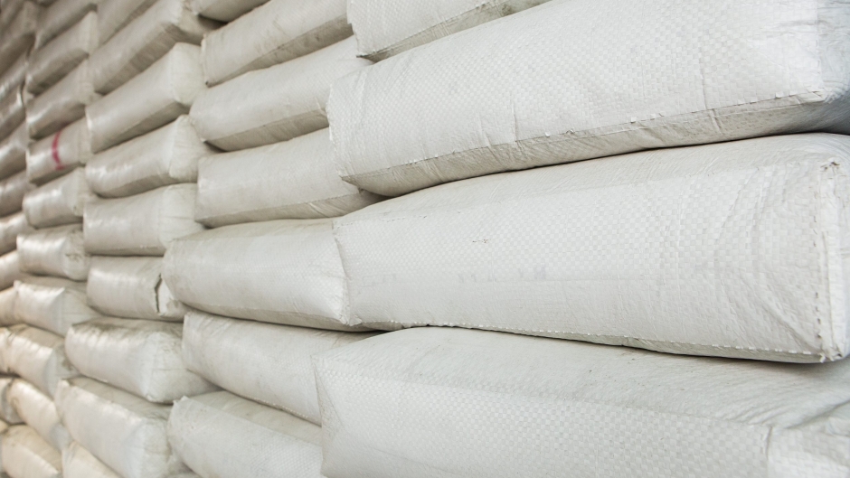 Pile,Of,White,Plastic,Sacks,In,Warehouse